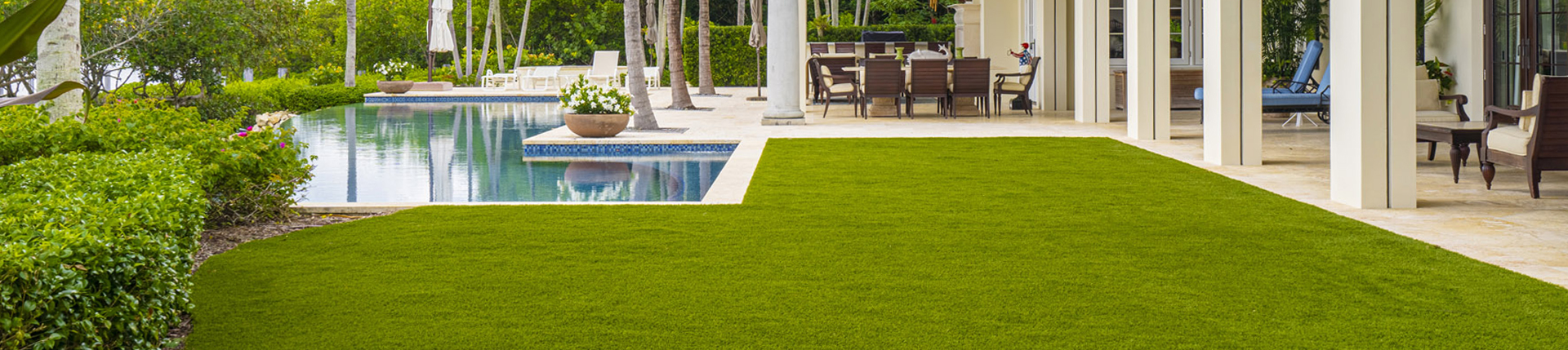 Synthetic turf lawn next to a backyard pool