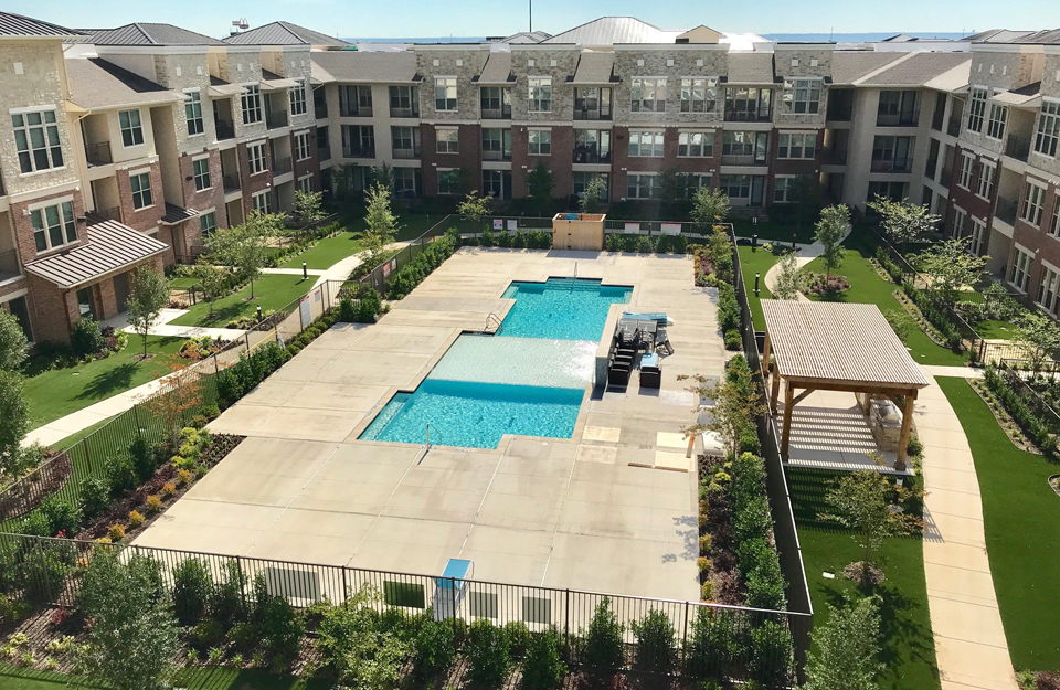 Community courtyard installed with artificial grass lawns