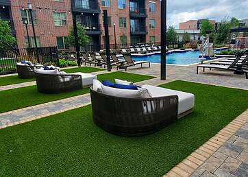 Artificial grass installed around a pool at an apartment complex