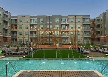 Synthetic grass installed as a pool surround at a luxury apartment complex