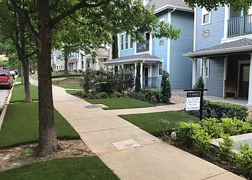 Town homes with synthetic grass lawns
