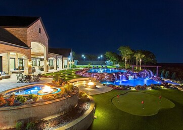 Backyard putting green next to a swimming pool