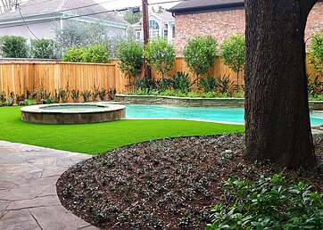 Artificial grass lawn in the backyard of a home