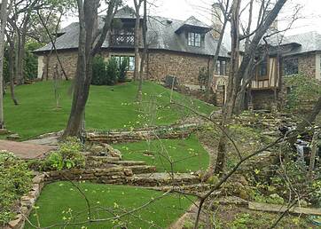 Large backyard hill installed with artificial grass