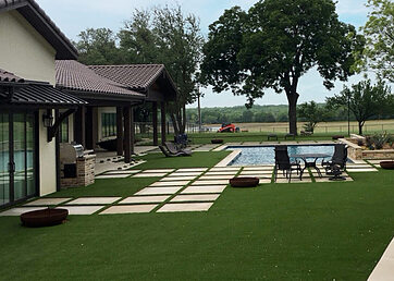 Artificial grass lawn installed around the backyard pool