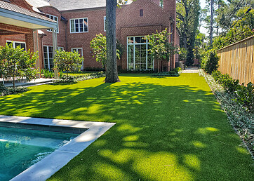 Synthetic grass lawns in the backyard of a home